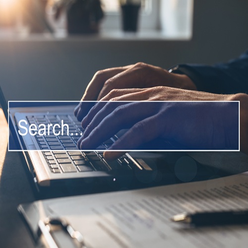 Man Tapping Laptop Keyboard And Search Page On Computer Touch Screen. Concept Searching New Job. Copy Space.